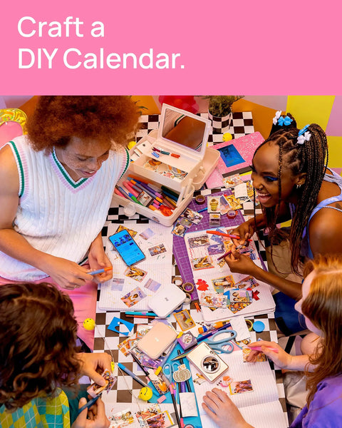 Group making a DIY calendar with Ivy 2 Mini Photo Printer For IPhone And Android Zero Ink ZINK Tech Print Sticky Back Photos On The Go