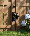 INOOMP 1Set Gate Lock for Outdoor Fence, 2-Sided Self-Locking Latch w Key mounted on a wooden fence with a key and flowers.