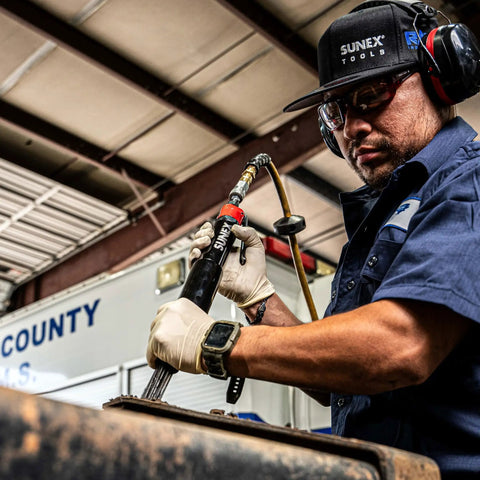 Worker using Beast Heavy Duty Air Needle Scaler for tough surface prep, rust and paint removal in an industrial setting.
