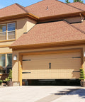 Front view of a garage with Steel Garage Door Decorative Hinges, Handles And Accents Hardware Kit With Screw Mount In Black Powder Coat installed