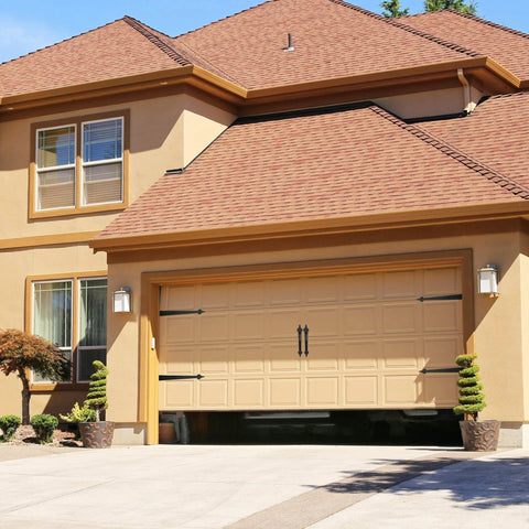 Front view of a garage with Steel Garage Door Decorative Hinges, Handles And Accents Hardware Kit With Screw Mount In Black Powder Coat installed