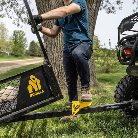 Person using Heavy Duty ATV Trailer With 27.5 Cu Ft Bed, 1,400 Lb Load Capacity, Black Steel Utility Dump Cart with tailgate