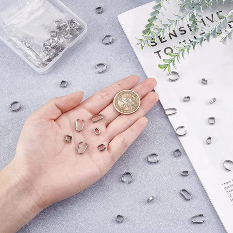 Hand holding Stainless Steel Pinch Bail Clasps Set, 200 Pcs in 4 Styles, Square and Oval Bead Connectors with a coin for scale.
