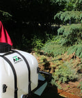 Person using 9 Gallon UTV And ATV Spot Sprayer with Everflo 1.0 GPM Diaphragm Pump for tree spraying in a garden.