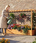 Raised Garden Bed With Trellis And Hanging Roof Wood Planter Box With Drainage Holes shown with flowers and vines outdoors.