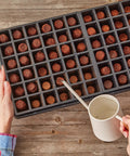 Adding water to Self Watering Seed Starter Kit With 72 Cells Two Trays Stands Dome Water Reservoir And Pellets for indoor gardening