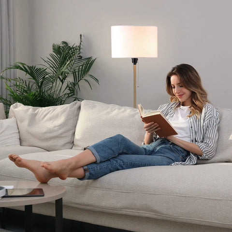 Woman reading beside Drum Shade Standing Lamp With Pull Chain Switch, E26 Socket, Dope Modern Minimalist Floor Lamp In Antique Brass