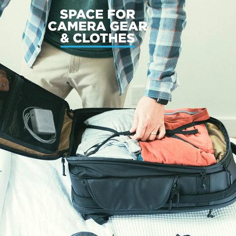 Person packing the Peter McKinnon Collab Camera Pack Expandable 35L To 42L Travel DSLR Backpack with camera gear and clothes.