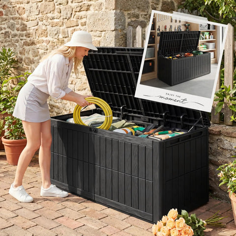 Woman using Big 120 Gallon Outdoor Deck Box Lockable Waterproof Storage Chest for Patio Cushions, Garden Tools, Packages and More