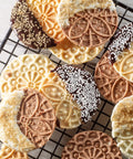 Delicious mini Italian cookies made with Piccolo Non Stick Electric Pizzelle Baker, decorated with chocolate and sprinkles.