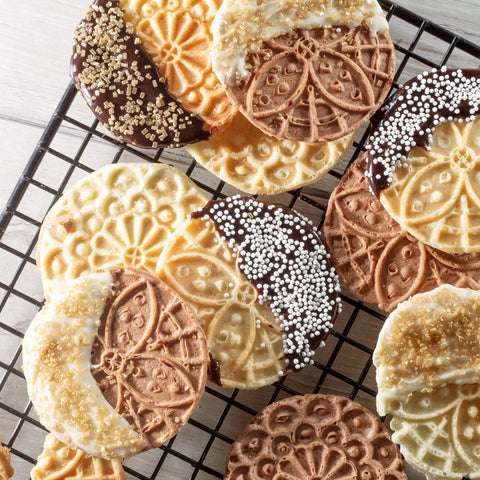 Delicious mini Italian cookies made with Piccolo Non Stick Electric Pizzelle Baker, decorated with chocolate and sprinkles.