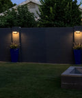 2 Pack Solar Motion Sensor Outdoor Lights With 600 Lumen Brightness illuminating a yard fence; dusk setting, no wiring needed.