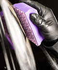 Person using Hookit Dust Extraction Flexible Sanding Block Kit With Four Lengths For Automotive Sanding, capturing dust with vacuum system.
