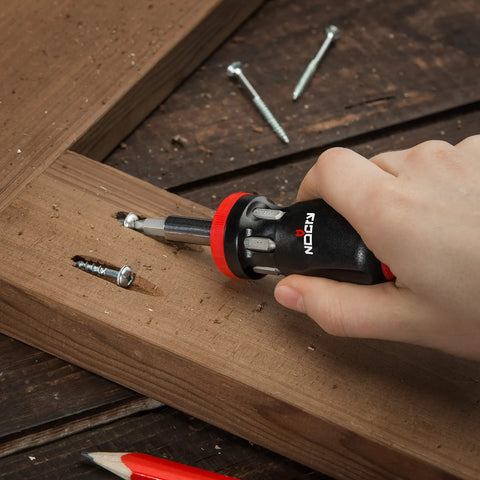 Stubby Ratcheting Screwdriver Kit With 14-In-1 Mini Bit Set Including Flathead, Hex, Torx, Square, And Pozidriv Tips in use on wood