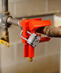 Red Prinzing Ball Valve Lockout for 2 to 8 inch pipes mounted with padlock for industrial safety equipment use