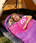 Person sleeping in Purple Three Season Sleeping Bag For All Weather Kids Teens And Adults Waterproof Lightweight Outdoor Gear