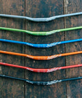 Colorful Speedrun Junior Mountain Bike Handlebars with Bar Clamp 31.8mm, 680mm Width, AL6061 Aluminum, on wooden surface