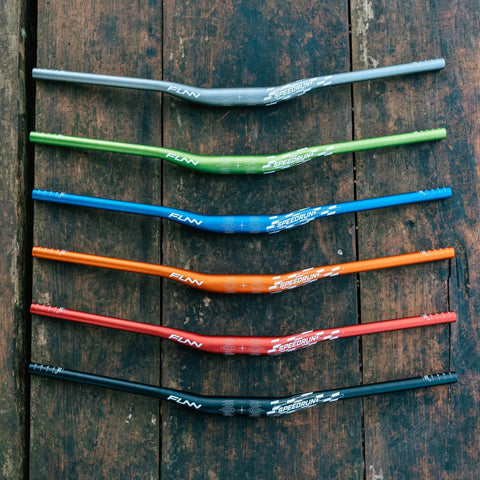 Colorful Speedrun Junior Mountain Bike Handlebars with Bar Clamp 31.8mm, 680mm Width, AL6061 Aluminum, on wooden surface