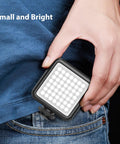 VL49 2000mAh LED Video Light With 3 Cold Shoe Mounts held beside jeans for size comparison