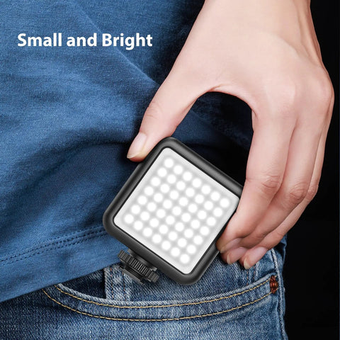 VL49 2000mAh LED Video Light With 3 Cold Shoe Mounts held beside jeans for size comparison