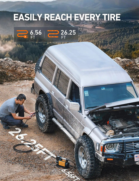 Man using Trail Ready Portable Air Compressor Bad Boy 12 Volt Tire Inflator on SUV tire with 26 ft hose at outdoor site.