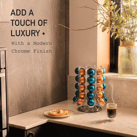 Boss Level Nespresso Vertuo Capsule Holder Rack For 70 Pods 40 On Outer Display And 30 In Carousel 360 Degree Rotating Chrome Pod Storage Organizer Stand For A Clutter Free Coffee Bar on marble countertop beside coffee and pastry.