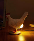 Lit 3D Lifelike Chicken Egg Lamp Night Light on desk, resin egg table lamp with USB, glowing LED light for bedroom or living room.