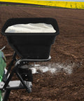 Tow Behind 12V Lawn Tractor Spreader for grass seed and fertilizer with 80 pound capacity spreading on large field