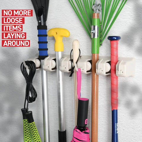 Mop and Broom Holder Wall Mount with Five Slots and Six Hooks, holding various tools in a garage or home setting, off white.