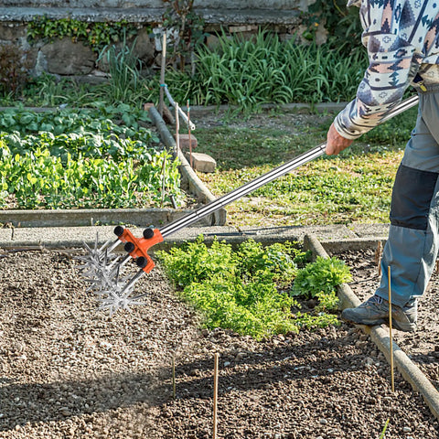 Person using Rotary Cultivator Garden Tiller With Adjustable Stainless Steel Handle, Ultra Lightweight Aluminum Tines And Wheels