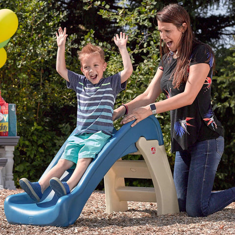 Child sliding down a blue and beige Play And Fold Junior Slide For Toddlers 1.5 To 4 Years Old Indoor Outdoor Backyard Playground Set
