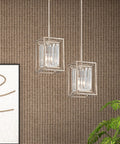 Linares 1 Light Mini Pendant With Crystal Prism Shade In Dope Aged Platinum Finish Steel Fixture hanging on textured wall