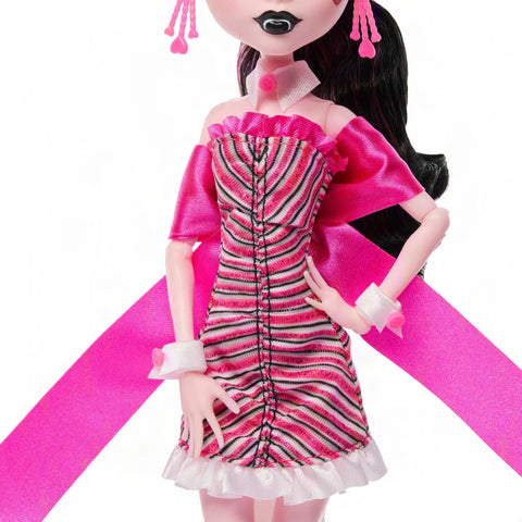 Iconic Design Draculaura Reproduction Doll In A Dope Pink Ruffle Dress featuring striped pink gown and accessories, perfect for display.