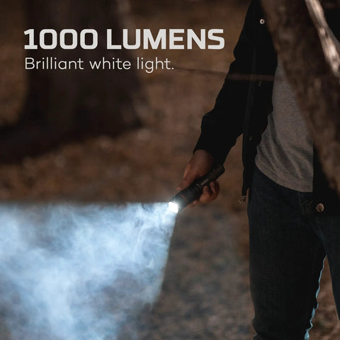 Person using DaVinci 1000 Lumen Flashlight And Portable Charger With Magnetic Base For Camping And Hunting Four Light Modes Fully Rechargeable Waterproof Handheld Beast Mode Brightness USB Cable Included in dark woods.