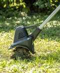 20V Cordless Garden Tiller Cultivator with 7.5 Inch Width in action on grassy terrain