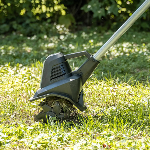 20V Cordless Garden Tiller Cultivator with 7.5 Inch Width in action on grassy terrain
