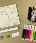 Make Your Own Moth Man Magnet Craft Kit For Kids And Adults with wood pop-out, 12 markers, glue pen, magnets on table