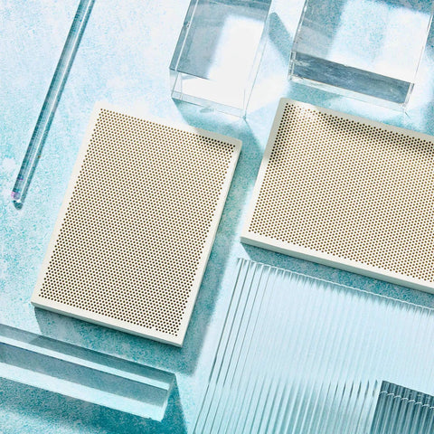 Two Piece Honeycomb Ceramic Soldering Board Set for Jewelry Making on glass surface, showcasing heat-resistant quartz panels.