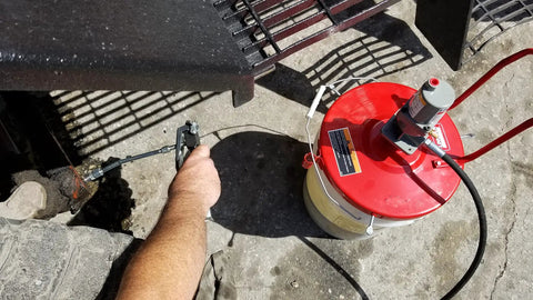 Pneumatic Grease Pump For 25-50Lb Pails, 40:1 Ratio Up To 4,000 PSI, 7 Ft High Pressure Hose, Control Valve in use.
