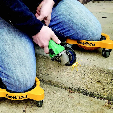 User wearing Heavy Duty Knee Blades With Gel Cushions And Three Casters For Unisex Adults, using grinder on concrete step.