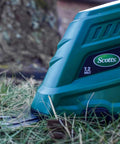 Close-up of Cordless Grass Shear And Shrub Trimmer With Wheeled Extension Handle Seven Point Two Volt Lithium Ion Battery in grass