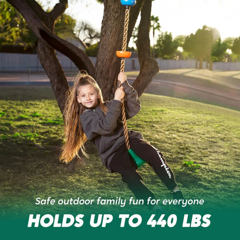Kid Friendly Tree Swing With Disc Seat And Climbing Rope Carabiner And 4 Ft Strap Easy Install in use by a child outdoors