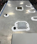 Heavy Duty Silicone Roof Patch Kit 2 Gallon Black applied on RV roof, sealing vents and edges for waterproofing.