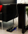 UltraPro 10 Outlet Surge Protector With USB Charging And Two USB Ports 2880 Joules 4 Foot Cord Black placed near sofa