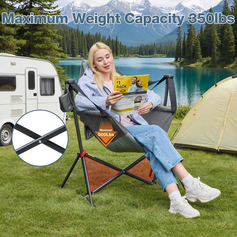 Person seated in grey oversized hammock camping chair with adjustable backrest, reading by a lake. Heavy duty, 350 lbs capacity.