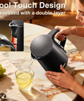 Woman pouring hot water from Compact 0.8L Travel Electric Kettle With Double Wall 304 Stainless Steel Auto Shut Off Portable Kettle for business trips
