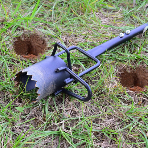 Long Handle Bulb Planter With Serrated Base For Easy Grass Plugging And Bulb Transplanting lying on grass next to holes