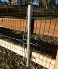 32-Inch Woven Wire Fence Stretcher With 3-Hook Bar Pro-Grade Galvanized Steel Construction in use on wooden fence