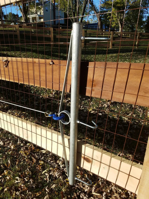 32-Inch Woven Wire Fence Stretcher With 3-Hook Bar Pro-Grade Galvanized Steel Construction in use on wooden fence