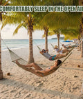 4 Pack Mesh Hammocks Set For Outdoor Chill Pine Green Nylon Hammocks 98.4 x 31.5 Inches holding people on the beach